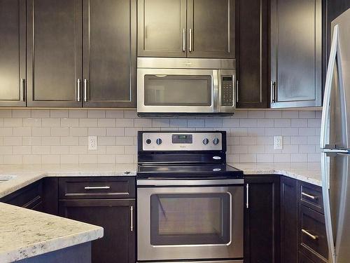 Edmonton, AB - Indoor Photo Showing Kitchen With Stainless Steel Kitchen With Upgraded Kitchen