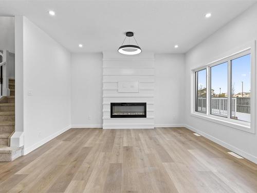 213 Kettyl Court, Leduc, AB - Indoor Photo Showing Living Room With Fireplace