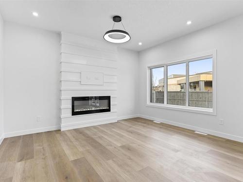 213 Kettyl Court, Leduc, AB - Indoor Photo Showing Living Room With Fireplace