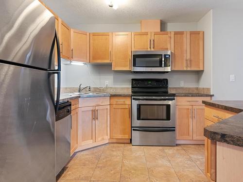 201 300 Spruce Ridge Road, Spruce Grove, AB - Indoor Photo Showing Kitchen With Stainless Steel Kitchen With Double Sink