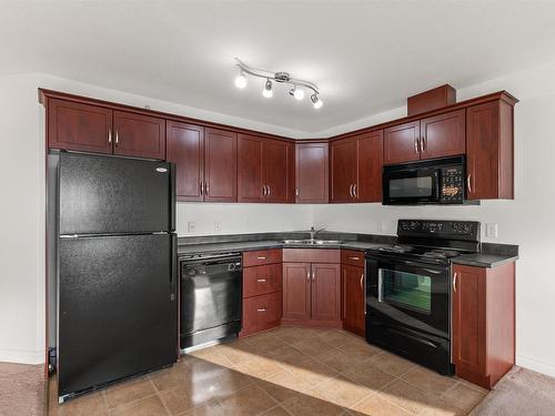 512 9910 107 Street, Morinville, AB - Indoor Photo Showing Kitchen With Double Sink