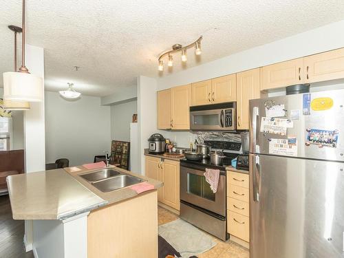 A313 11445 Ellerslie Road Sw, Edmonton, AB - Indoor Photo Showing Kitchen With Stainless Steel Kitchen With Double Sink