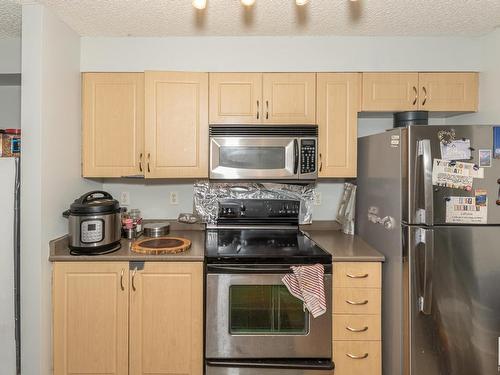 A313 11445 Ellerslie Road Sw, Edmonton, AB - Indoor Photo Showing Kitchen With Stainless Steel Kitchen