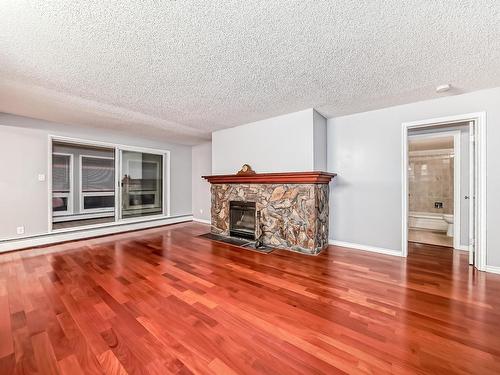 18 10160 119 Street Nw, Edmonton, AB - Indoor Photo Showing Living Room With Fireplace