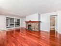 18 10160 119 Street Nw, Edmonton, AB  - Indoor Photo Showing Living Room With Fireplace 