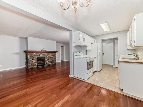 18 10160 119 Street Nw, Edmonton, AB - Indoor Photo Showing Kitchen With Fireplace With Double Sink