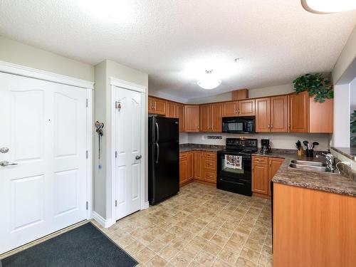 326 7801 Golf Course Road, Stony Plain, AB - Indoor Photo Showing Kitchen With Double Sink