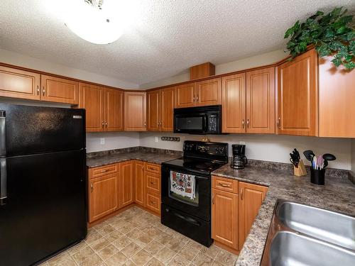 326 7801 Golf Course Road, Stony Plain, AB - Indoor Photo Showing Kitchen With Double Sink