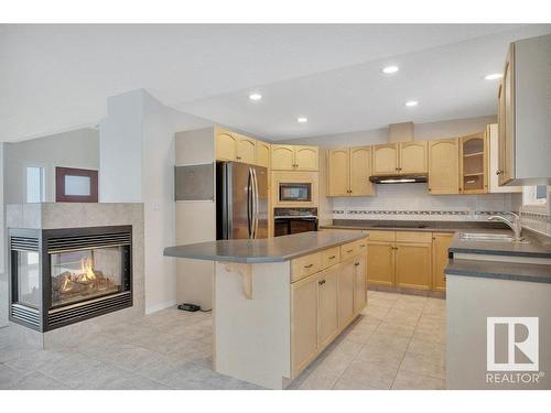 240 49547 Rge Road 243, Rural Leduc County, AB - Indoor Photo Showing Kitchen With Fireplace With Double Sink