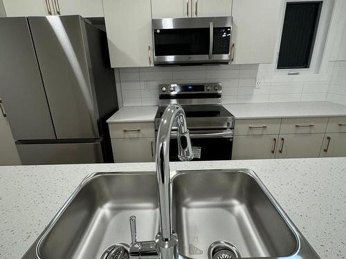 115 1025 Secord Promenade Nw, Edmonton, AB - Indoor Photo Showing Kitchen With Double Sink