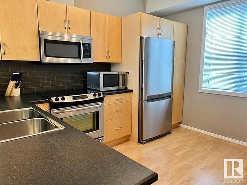 400 9940 Sherridon Drive, Fort Saskatchewan, AB - Indoor Photo Showing Kitchen With Double Sink