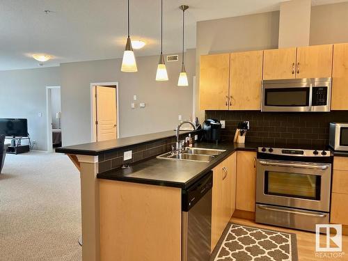 400 9940 Sherridon Drive, Fort Saskatchewan, AB - Indoor Photo Showing Kitchen With Double Sink