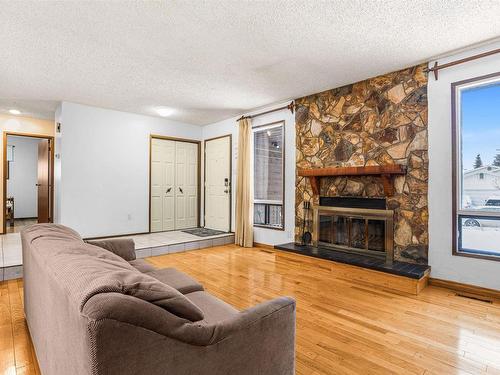 6327 12 Avenue, Edmonton, AB - Indoor Photo Showing Living Room With Fireplace