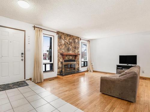 6327 12 Avenue, Edmonton, AB - Indoor Photo Showing Living Room With Fireplace