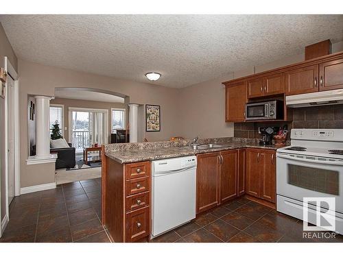 304 5204 52 Avenue, Tofield, AB - Indoor Photo Showing Kitchen With Double Sink