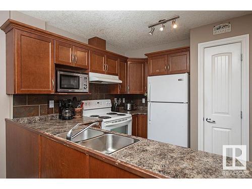 304 5204 52 Avenue, Tofield, AB - Indoor Photo Showing Kitchen With Double Sink