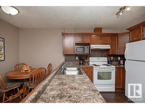 304 5204 52 Avenue, Tofield, AB - Indoor Photo Showing Kitchen With Double Sink