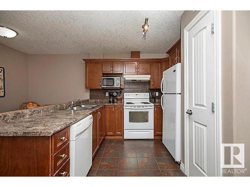 304 5204 52 Avenue, Tofield, AB - Indoor Photo Showing Kitchen With Double Sink