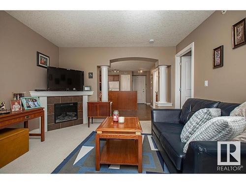 304 5204 52 Avenue, Tofield, AB - Indoor Photo Showing Living Room With Fireplace