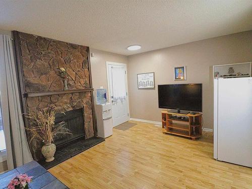 121 10787 31 Avenue, Edmonton, AB - Indoor Photo Showing Living Room With Fireplace