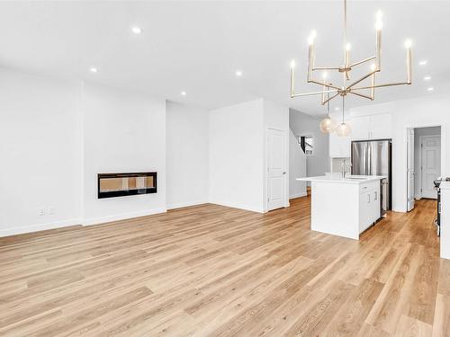 2215 Muckleplum Crescent, Edmonton, AB - Indoor Photo Showing Other Room With Fireplace