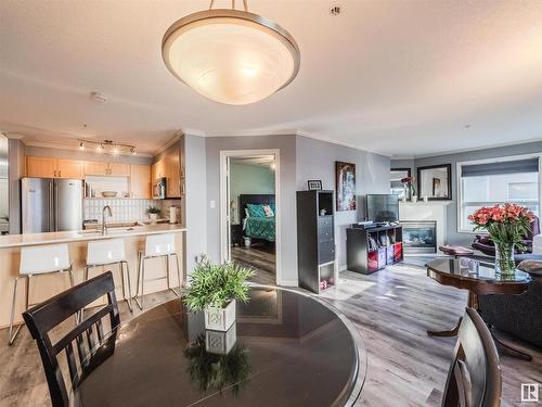 310 9938 104 Street, Edmonton, AB - Indoor Photo Showing Dining Room With Fireplace