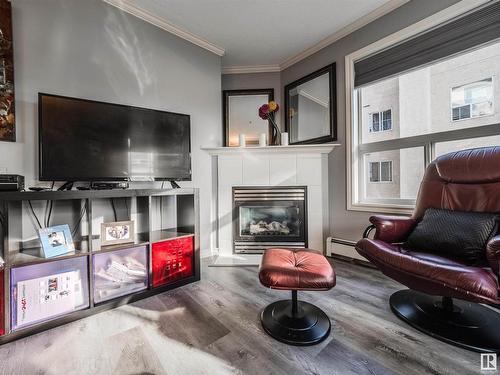 310 9938 104 Street, Edmonton, AB - Indoor Photo Showing Living Room With Fireplace