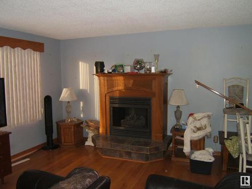 4221 50 Street, Vegreville, AB - Indoor Photo Showing Living Room With Fireplace