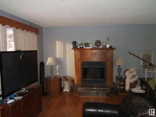 4221 50 Street, Vegreville, AB - Indoor Photo Showing Living Room With Fireplace