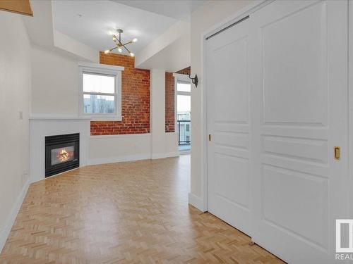 406 10728 82 Avenue, Edmonton, AB - Indoor Photo Showing Other Room With Fireplace