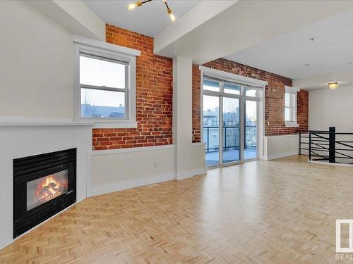 406 10728 82 Avenue, Edmonton, AB - Indoor Photo Showing Living Room With Fireplace