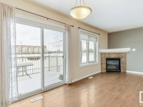 128 5420 Grant Macewan Blvd, Leduc, AB - Indoor Photo Showing Living Room With Fireplace