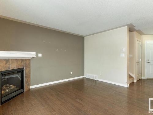 128 5420 Grant Macewan Blvd, Leduc, AB - Indoor With Fireplace