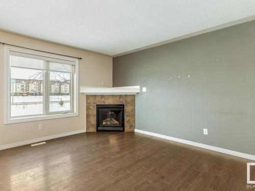 128 5420 Grant Macewan Blvd, Leduc, AB - Indoor Photo Showing Living Room With Fireplace