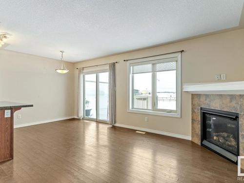 128 5420 Grant Macewan Blvd, Leduc, AB - Indoor Photo Showing Living Room With Fireplace