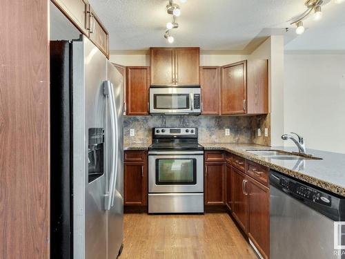 128 5420 Grant Macewan Blvd, Leduc, AB - Indoor Photo Showing Kitchen With Double Sink