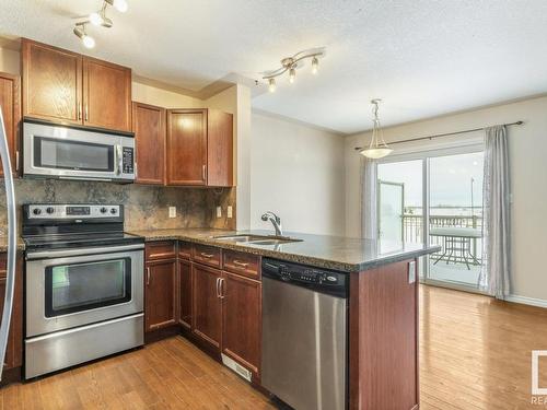 128 5420 Grant Macewan Blvd, Leduc, AB - Indoor Photo Showing Kitchen With Double Sink