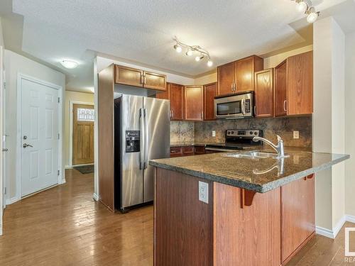 128 5420 Grant Macewan Blvd, Leduc, AB - Indoor Photo Showing Kitchen With Double Sink