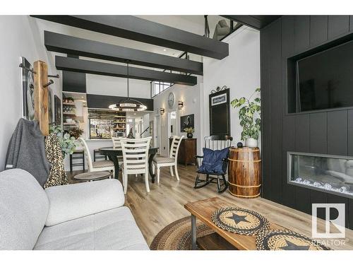 404 9940 Sherridon Drive, Fort Saskatchewan, AB - Indoor Photo Showing Living Room With Fireplace