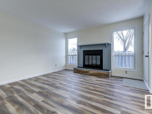 14 4610 17 Avenue, Edmonton, AB - Indoor Photo Showing Living Room With Fireplace