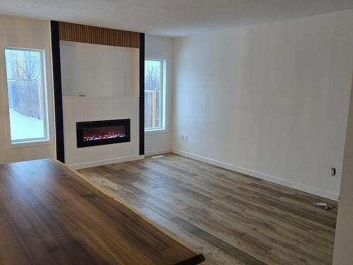 Edmonton, AB - Indoor Photo Showing Living Room With Fireplace