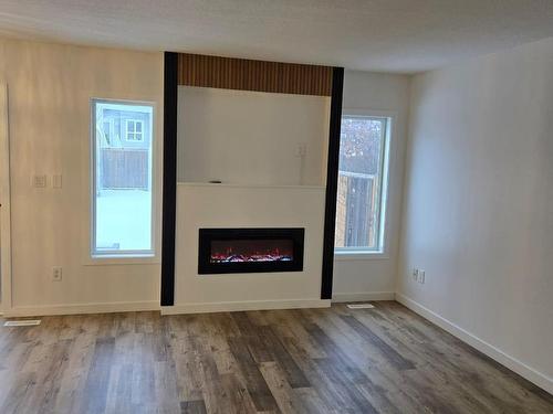 Edmonton, AB - Indoor Photo Showing Living Room With Fireplace