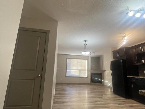 22 1820 34 Avenue, Edmonton, AB - Indoor Photo Showing Kitchen With Fireplace