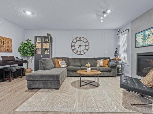 142 Radcliffe Wynd, Fort Saskatchewan, AB - Indoor Photo Showing Living Room With Fireplace