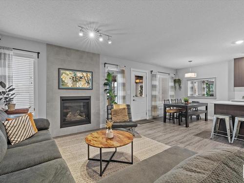 142 Radcliffe Wynd, Fort Saskatchewan, AB - Indoor Photo Showing Living Room With Fireplace