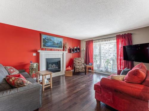 3819 23 Street, Edmonton, AB - Indoor Photo Showing Living Room With Fireplace