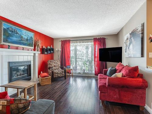 3819 23 Street, Edmonton, AB - Indoor Photo Showing Living Room With Fireplace