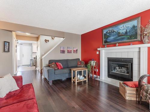 3819 23 Street, Edmonton, AB - Indoor Photo Showing Living Room With Fireplace