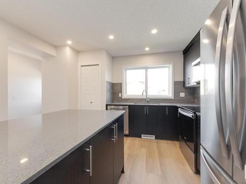 127 Stiles Link, Leduc, AB - Indoor Photo Showing Kitchen With Upgraded Kitchen