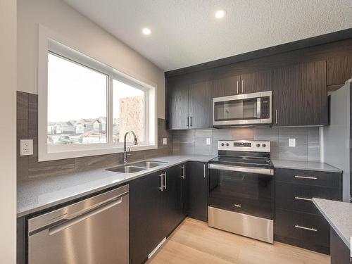 127 Stiles Link, Leduc, AB - Indoor Photo Showing Kitchen With Stainless Steel Kitchen With Double Sink With Upgraded Kitchen